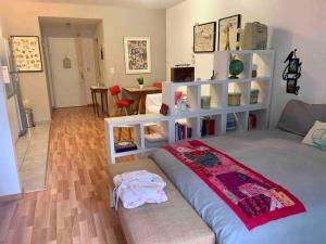 a bedroom with a bed and a room with a table at Apartamento en Palermo Hollywood in Buenos Aires