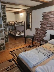 a room with two bunk beds and a fireplace at Oasis Guest House in Dobrinishte
