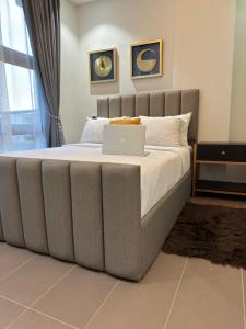 a bedroom with a bed with a laptop on it at Studio Apartment in Accra