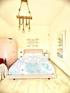 a bedroom with a bed and a chandelier at Relax House in Bari