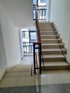 a staircase in a building with a wooden railing at Voyager 002 in Nairobi