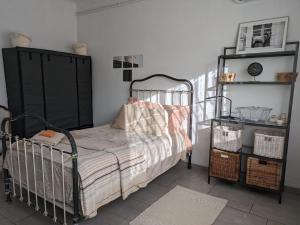 a small bedroom with a bed and a shelf at Maison d'Hôte du Jas in Ensuès-la-Redonne