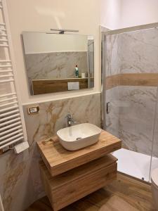 a bathroom with a sink and a shower at LA TORTORELLA HOME DI ROMA TALENTI in Rome +52 photos