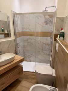 a bathroom with a shower and a toilet and a sink at LA TORTORELLA HOME DI ROMA TALENTI in Rome