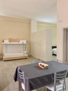 a room with a table and chairs and a bed at Palazzo Greco Case Vacanze in Porto Cesareo