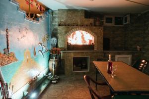a dining room with a fireplace and a table with a table at GUEST HOUSE OCEAN FORCE in Batumi
