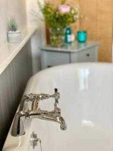 a bathroom sink with a chrome bathroom faucet at Luxurious Town House for 4 in Desirable Ludlow - pet friendly in Ludlow