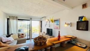 a living room with a table and a couch at Appartement Cocody 3 LUMIO in Lumio