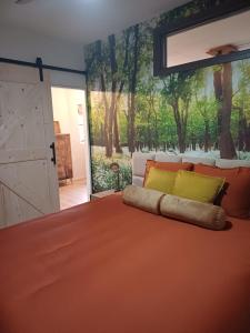 a bedroom with a large bed with a large sliding door at Bed & Breakfast Appenseweg in Voorst