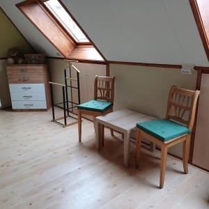 Voorst的住宿－Bed & Breakfast Appenseweg，窗户客房内的两把椅子和一张桌子