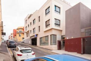 a white car parked in front of a building at Lovely Spacious Apartment in San Isidro Tenerife in San Isidro