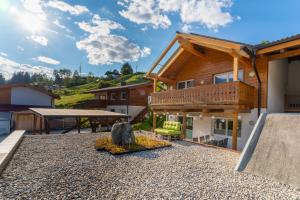 a house with a deck and a patio at Haus Floria Top 2 in Neukirchen am Großvenediger