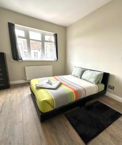 a bedroom with a large bed with a window at westcliff on sea in Southend-on-Sea