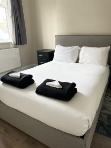 a bed with two towels sitting on top of it at westcliff on sea in Southend-on-Sea
