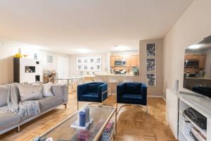 a living room with a couch and two blue chairs at 1600ft TriBeCa Townhouse - Luxury & Spacious in New York