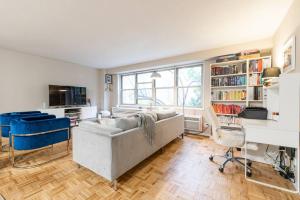 a living room with a couch and a table and chairs at 1600ft TriBeCa Townhouse - Luxury & Spacious in New York