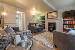 uma sala de estar com um sofá e uma mesa em Bracken Cottage em Brancaster