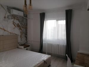 a bedroom with a bed and a window at Luxury 4-rooms, 2-bathrooms, Obor area in Bucharest