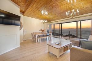 a living room with a couch and a table at Zaria Sun Penthouse by Host Agents in Cape Town