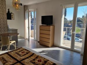 a bedroom with a bed and a television and a table at Aura Mura in Peschiera del Garda