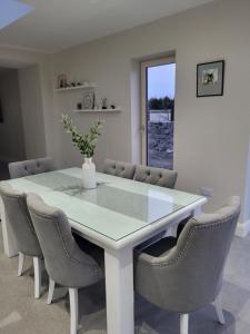 a dining room with a white table and chairs at Blackriver House in Shruthair
