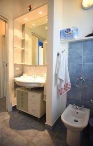 een badkamer met een wastafel, een toilet en een spiegel bij Borgo Rio Favara residence - appartamenti in Santa Maria Del Focallo