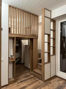 a room with a book shelf and a staircase at Despina's Apartment in Mavrovi Anovi
