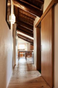 a hallway with a wooden floor and a table at L’Abbaino in Vicenza