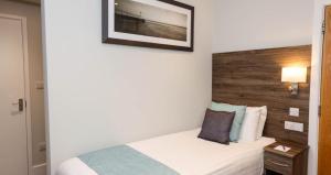 a bedroom with a bed and a picture on the wall at Silk Accommodation in Margate
