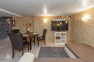 a room with a table and chairs and a kitchen at Spacious Studio apartment by Polo apartments in Kaunas