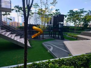 a playground with a yellow slide in a park at Bunga Suite at Lucentia BBCC in Kuala Lumpur