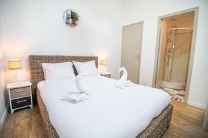 ein Schlafzimmer mit einem großen Bett mit weißer Bettwäsche in der Unterkunft Sur la route du Château d’Amboise in Amboise