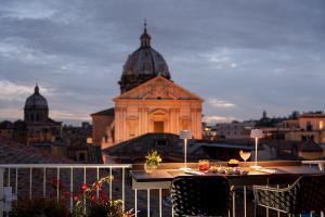 a table on a balcony with a view of a building at Palazzo Navona Hotel in Rome