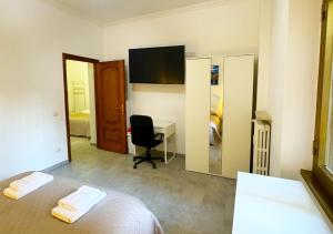 a hotel room with a bed and a desk and a mirror at Il Giardino Di Maria - Metro C in Rome