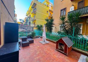 a patio with a dog house on a brick floor at Il Giardino Di Maria - Metro C in Rome