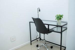 a black desk and a black chair in a room at Urban Oasis Apartments at Freedom Plaza in Windhoek