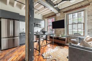 a kitchen with a table in the middle of a room at Ironworks Building- 1 Bedroom 1 Bath in New Orleans