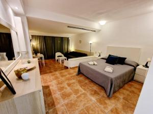 a bedroom with a large bed and a living room at La Petunia in Mijas Costa