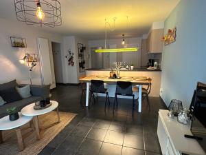 a living room and kitchen with a table and chairs at Zeewinde in Bredene