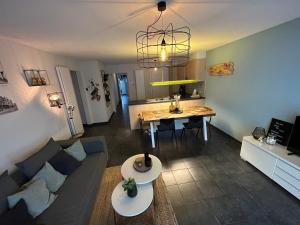 a living room with a couch and a table at Zeewinde in Bredene
