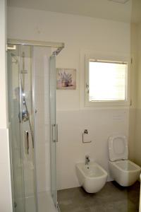 a bathroom with a shower and a toilet and a sink at Aura Mura in Peschiera del Garda