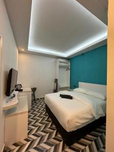 sypialnia z łóżkiem, biurkiem i telewizorem w obiekcie D SEGA HOTEL w mieście Macang