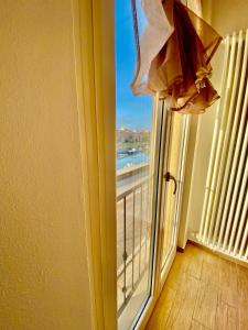 a room with a window with a view of a beach at Appartamento vista mare! in Fano
