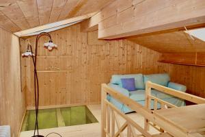 a room with a bunk bed in a wooden cabin at Fiemme Village in Bellamonte