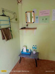 a small table in a room with a mirror at Ameen Homestay อามีน โฮมสเตย์ in Ban Komo Sam Sip Paet