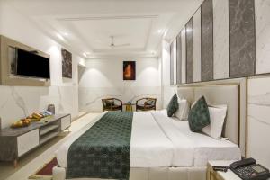 a bedroom with a large bed and a television at Hotel Transit International- Aerocity Delhi Airport in New Delhi