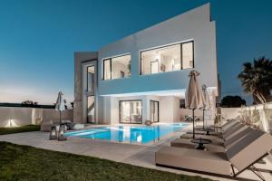 a villa with a swimming pool at night at Vorto Luxury Villas, a Signature Island Retreat, By ThinkVilla in Zakynthos