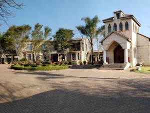 a large house with a driveway in front of it at Hole In One in Roodepoort