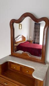 a mirror on top of a dresser in a bedroom at Casa Trend Hotel and Spa 