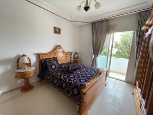 a bedroom with a bed and a large window at Casa Trend Hotel and Spa in Al Firnānah